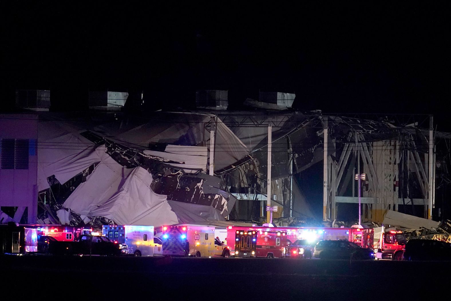 Rescue personnel work at an Amazon distribution center in Edwardsville, Illinois, that was heavily damaged during storms on Friday, December 10.