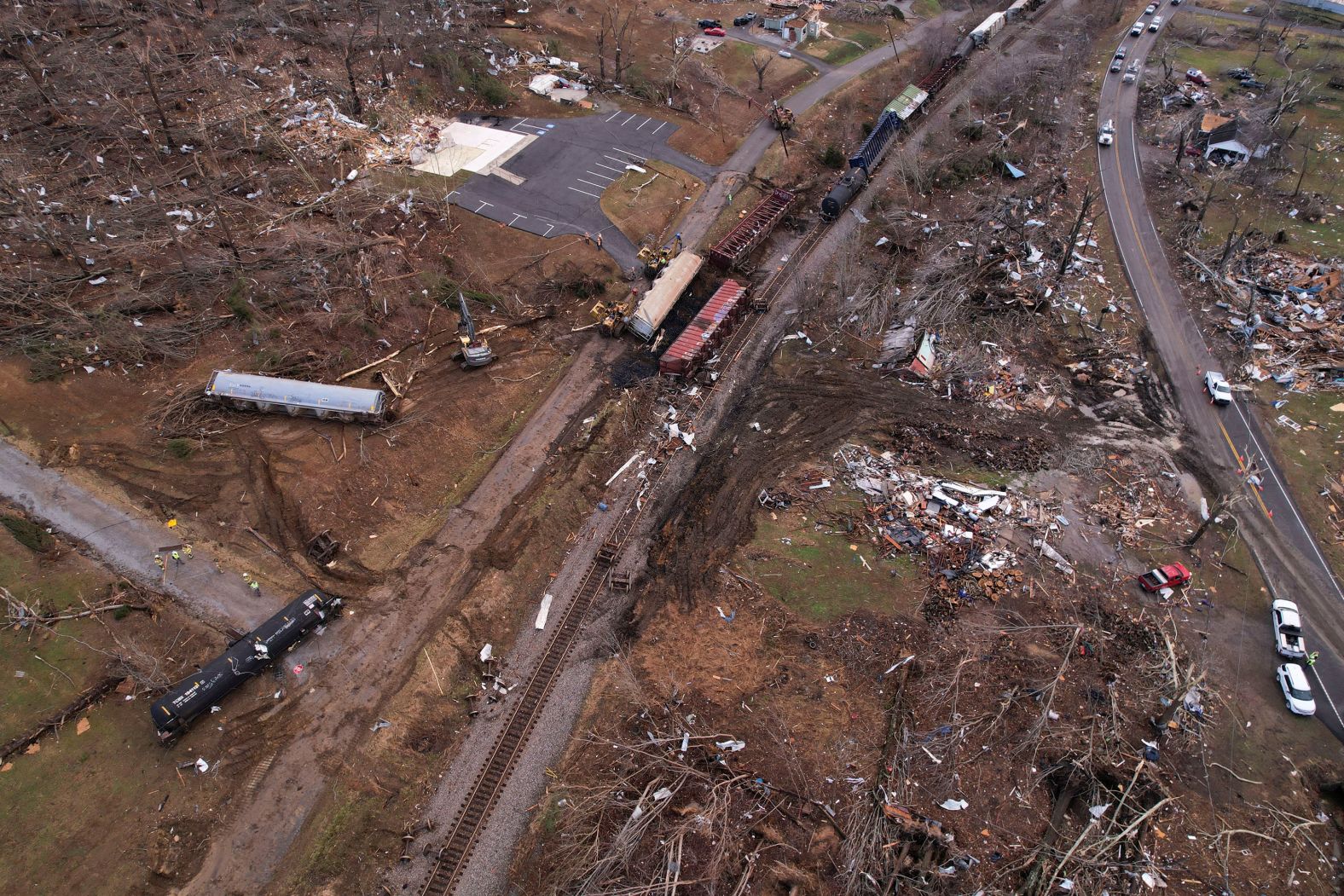 A derailed train is seen amid damage and debris in Earlington.