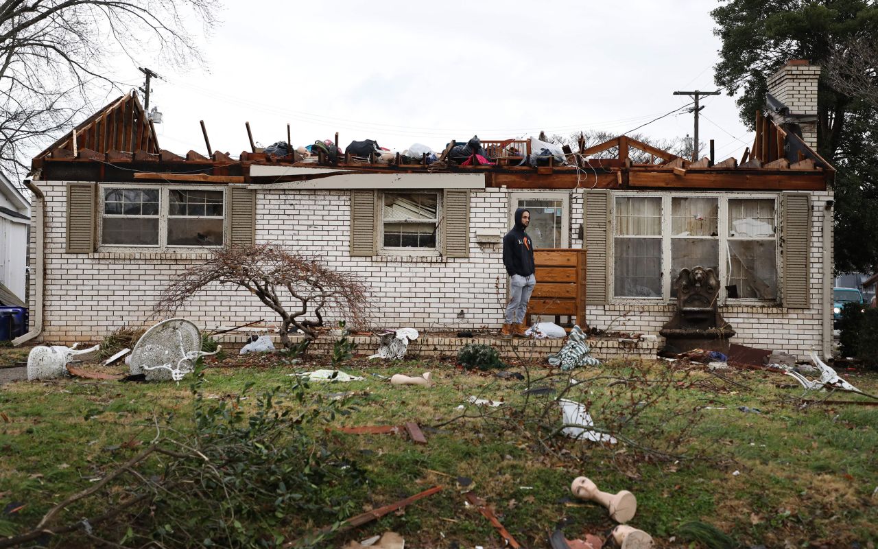 A person stands among the damage and debris in Bowling Green on Saturday, December 11.