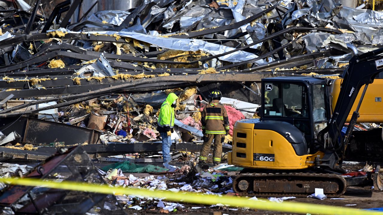 Emergency response workers dig through the rubble of the Mayfield Consumer Products candle factory in Mayfield, Kentucky, on Saturday.
