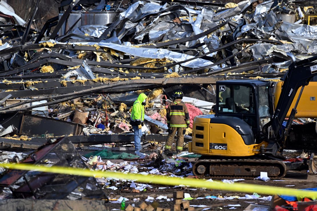 Emergency response workers dig through the rubble of the Mayfield Consumer Products candle factory in Mayfield, Kentucky, on Saturday.