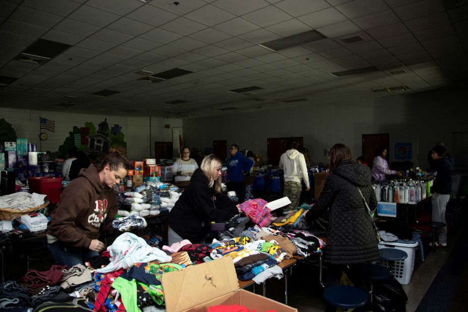 Volunteers at Henry Moss Middle School arrange donations for tornado victims on Saturday night in Bowling Green.