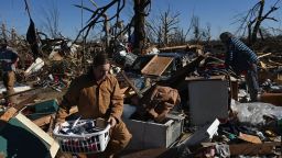 People gather belongings from a tornado damaged home after extreme weather hit the region December 12, 2021, in Mayfield, Kentucky. - Dozens of devastating tornadoes roared through five US states overnight, leaving more than 80 people dead Saturday in what President Joe Biden said was "one of the largest" storm outbreaks in history. (Photo by Brendan SMIALOWSKI / AFP) (Photo by BRENDAN SMIALOWSKI/AFP via Getty Images)