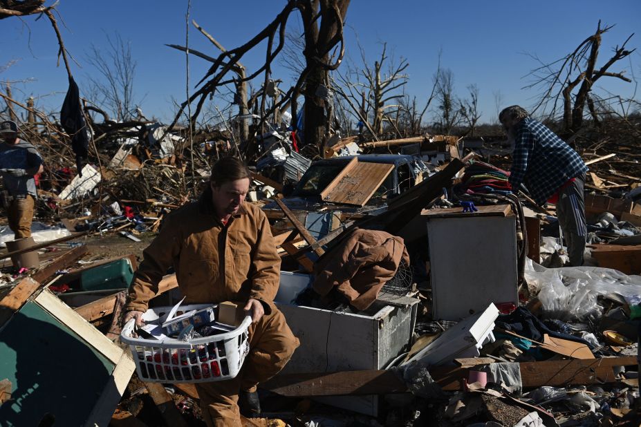 People gather belongings from a damaged home on December 12 in Mayfield.