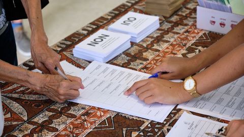 A man prepares to cast his ballot for the referendum on independence in Noumea, New Caledonia, on December 12.