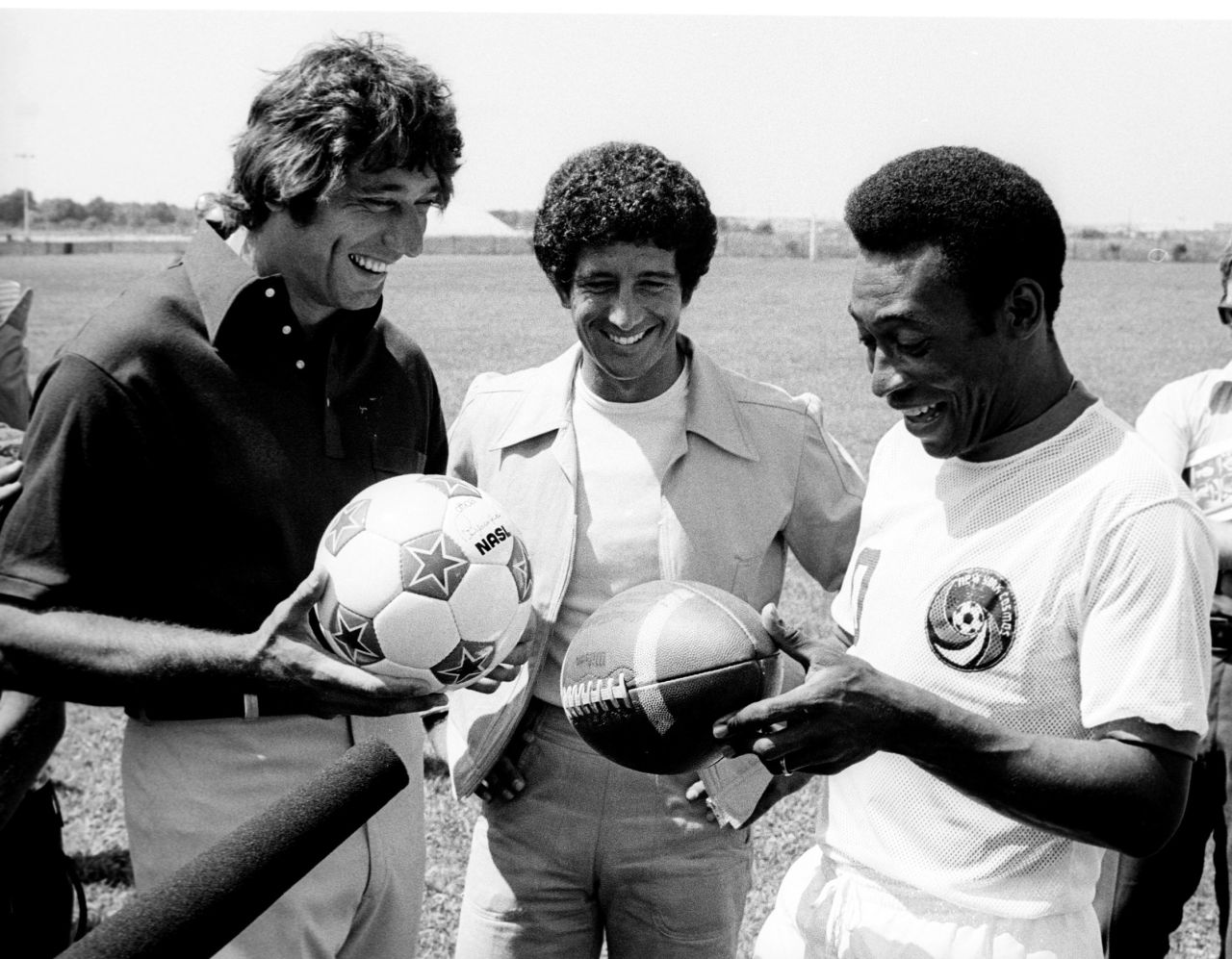 American football star Joe Namath, left, exchanges balls with Pelé during a promotional event in New York in 1975.