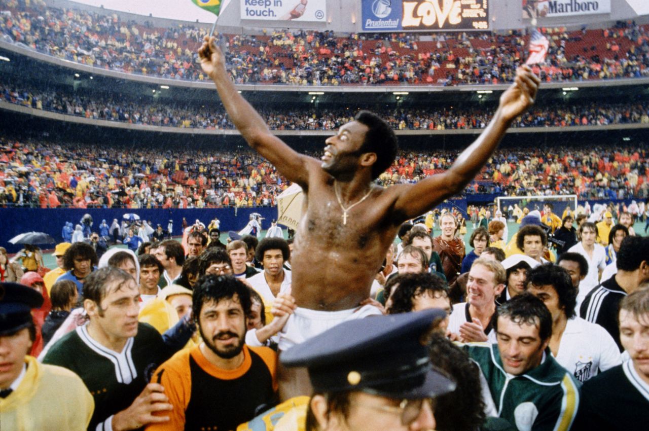 Pelé holds Brazilian and American flags aft  his last  lucifer  successful  1977. It was an accumulation  astatine  Giants Stadium betwixt  the Cosmos and his longtime Brazilian club, Santos. He played the archetypal  fractional  for the Cosmos and the 2nd  fractional  for Santos.