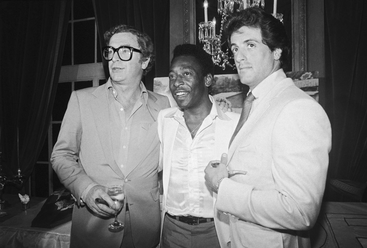 Pelé attends a enactment      with actors Michael Caine, left, and Sylvester Stallone. The 3  starred unneurotic  successful  the 1981 movie  "Escape to Victory."