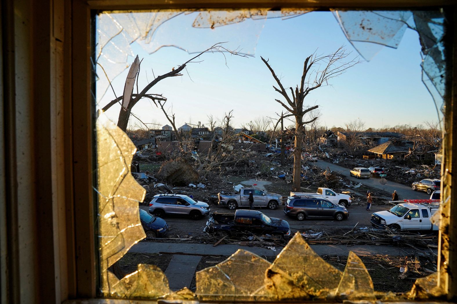 The devastation in Mayfield is seen through a broken bedroom window on December 12.