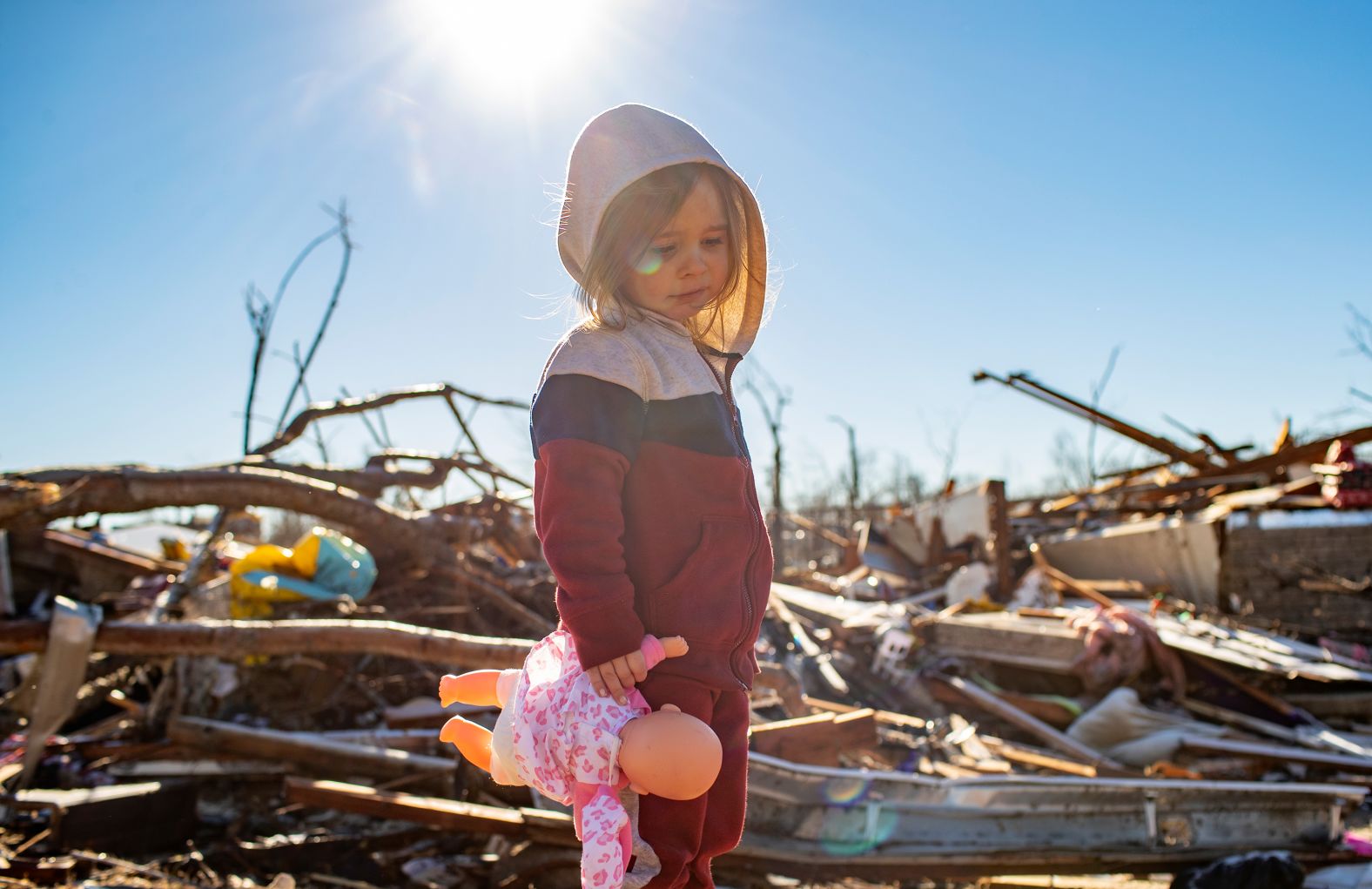Desiray Cartledge, 3, stands in the rubble of her house in Dawson Springs, Kentucky, on December 12.