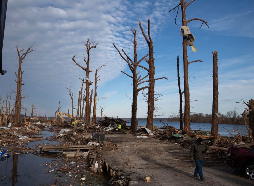 A man walks through a damaged area at Reelfoot Lake State Park in Tiptonville, Tennessee, on Saturday.