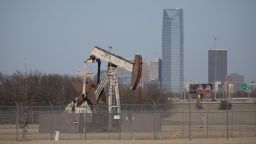An oil field pumping rig stands in an Oklahoma City, Oklahoma near downtown February 10, 2016. The Devon Oil Corporation headquarters is seen in the background. 