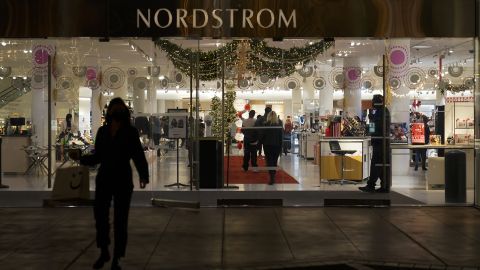 A security guard stands at the entrance to Nordstrom department store at The Grove in Los Angeles, where a recent smash-and-grab robbery took place.