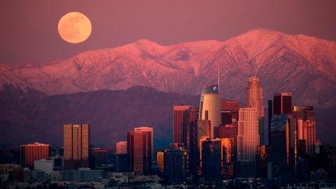 The last full moon of 2020, also known as the cold moon, rises behind the San Gabriel Mountains at sunset, as seen from the Kenneth Hahn State Recreation Area on December 29, 2020, in Los Angeles.