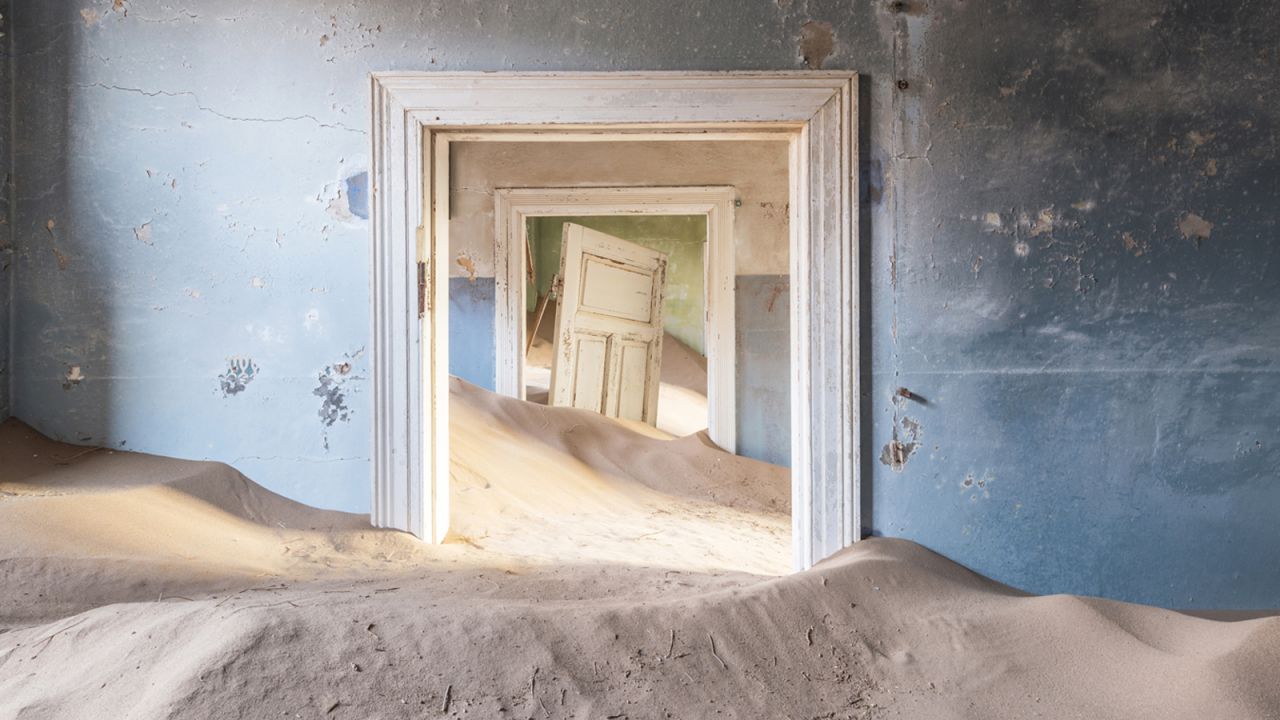 An image of abandoned Namibian ghost town Kolmanskop by photographer Romain Veillon.