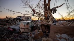 A car sits among the remains of a destroyed house after a tornado in Dawson Springs, Ky., Sunday, Dec. 12, 2021. A monstrous tornado, carving a track that could rival the longest on record, ripped across the middle of the U.S. on Friday. (AP Photo/Michael Clubb)