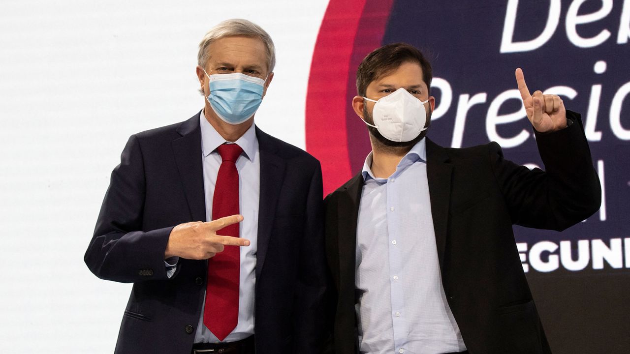 Chilean presidential candidates Gabriel Boric (right) and Jose Kast pose before a debate in Santiago, Chile on December 10. 