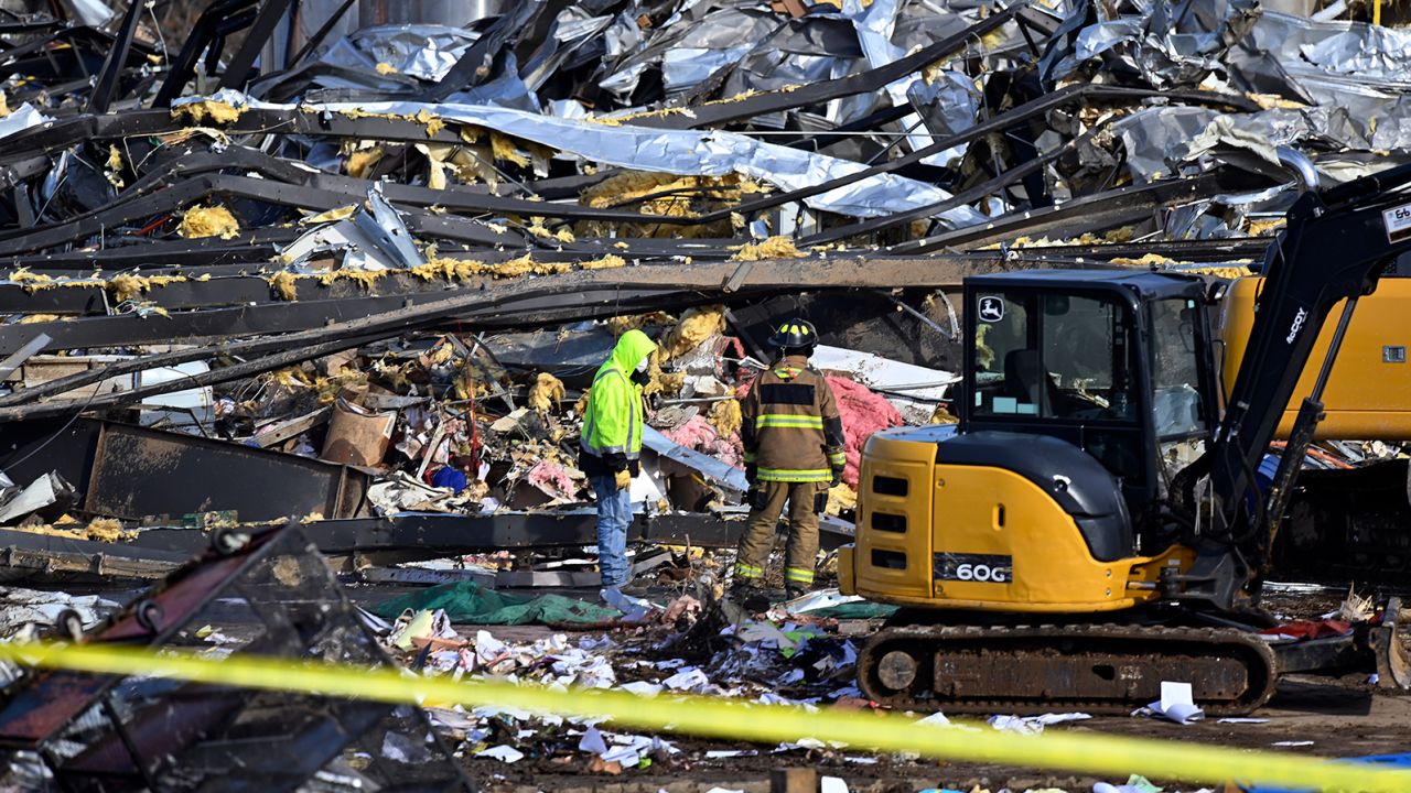 Emergency workers dig through the rubble of the Mayfield Consumer Products candle factory in Mayfield, Kentucky, on Saturday.