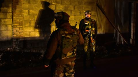 Paramilitary troopers stand guard at the site of an attack on the outskirts of Srinagar on December 13.