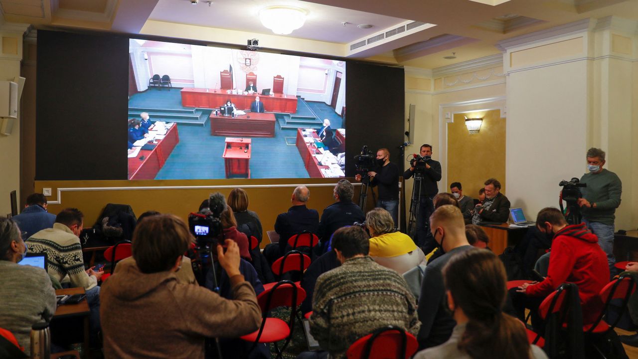Journalists gather in front of a screen broadcasting an earlier supreme court hearing in the Memorial case on December 14.