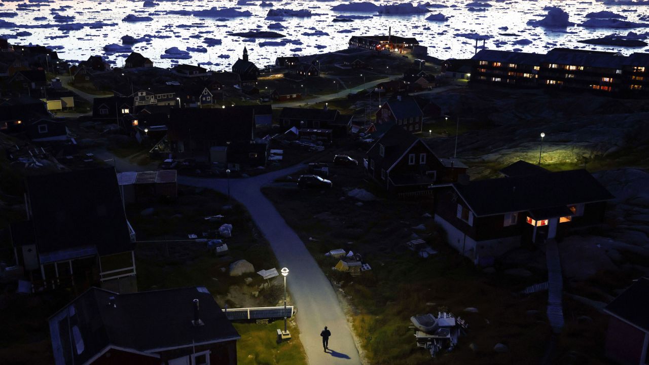 Ice and icebergs float in the distance in Disko Bay in September 2021 in Ilulissat, Greenland.