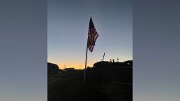 An American flag is seen in the rubble of Marsha Hall's home. It is one of 25 flags that used to fly in the front yard year-round. 