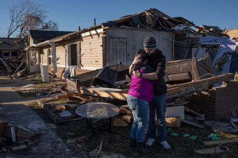 Devin Carlton consoles his fiancee, Asiah Alubahi, outside of where their former apartment used to be in Mayfield, Kentucky, on Monday, December 13. "We came back to try and recover the ultrasound of our daughter that we lost to a miscarriage in 2015," Alubahi said. "I started crying when we found it."