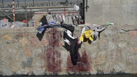 Clothes and blood stains of Afghans who were waiting to be evacuated are seen at the site of the ISIS bombing at Kabul airport on August 26.