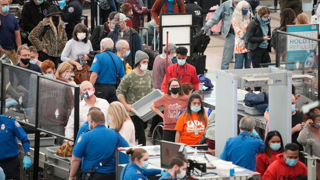 Travelers queue up at a security checkpoint on November 23, 2021, at Denver International Airport.