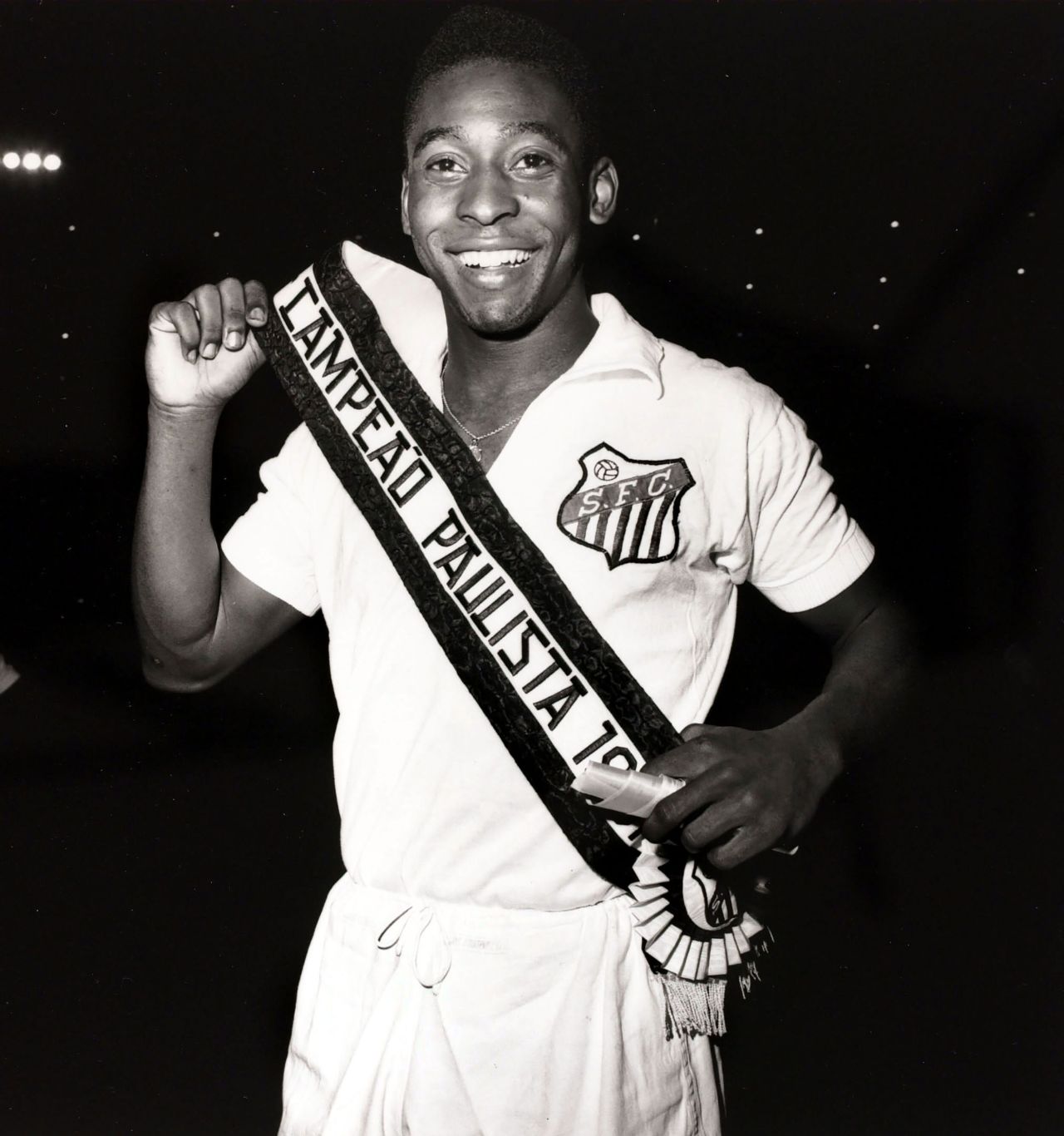 Pelé wears a sash aft  Santos became São Paulo authorities   champions successful  1961. Pelé played for the nine  from 1956-1974, scoring 618 goals and winning six Brazilian league   titles. In 1962 and 1963, Santos won the Copa Libertadores, which is South America's premier nine  competition.