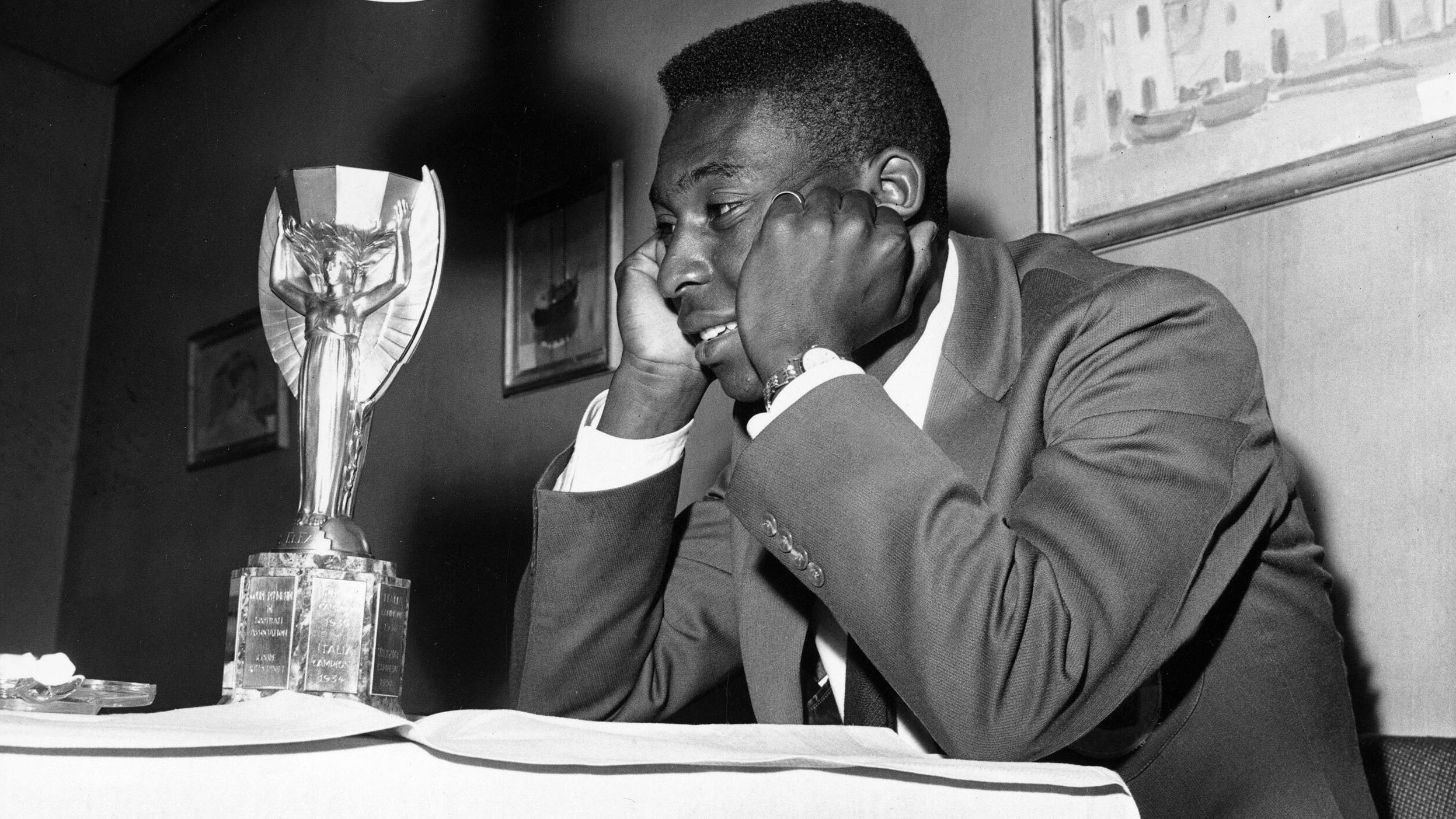 Pelé admires the Jules Rimet Trophy, the prize for winning the World Cup, circa 1958.