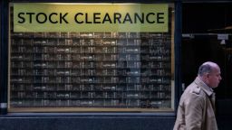 A pedestrian passes a closed clothing store in the City of London, U.K., on Tuesday, Dec. 14, 2021. U.K. companies added to payrolls in November at a record pace and unemployment fell, figures that are almost certain to fuel concerns at the Bank of England that unsustainable inflation pressures are building in the labor market. Photographer: Chris J. Ratcliffe/Bloomberg via Getty Images