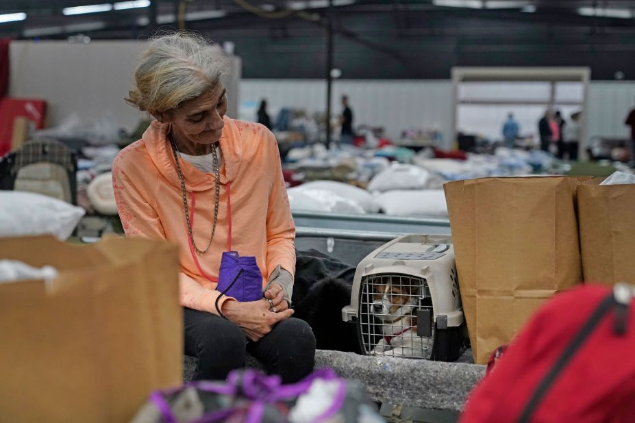 Christie Bonds sits with her 6-month-old dog "Jingles" in a shelter for the displaced, as she waits to be transported to better accommodations, in Wingo, Kentucky, on December 14.