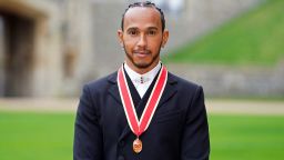 Mercedes' British F1 driver Lewis Hamilton poses with his medal after being appointed as a Knight Bachelor (Knighthood) for services to motorsports, by the Britain's Prince Charles, Prince of Wales, during a investiture ceremony at Windsor Castle in Windsor, west of London on December 15, 2021. - Lewis Hamilton received his knighthood on Wednesday as the British driver comes to terms with controversially losing the Formula One world title.