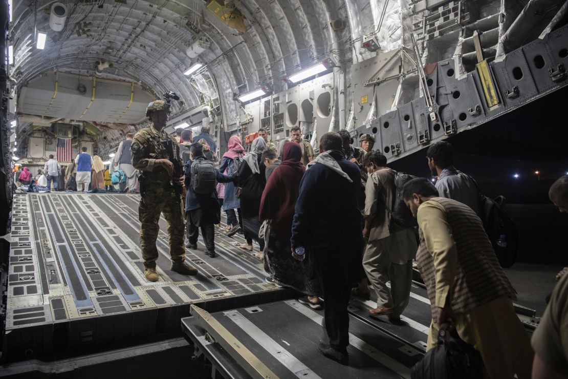 Afghan passengers board a US Air Force C-17 Globemaster III during the Afghanistan evacuation at Hamid Karzai International Airport in Kabul in August.