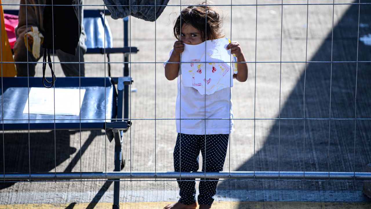 A young evacuee from Afghanistan holds up a drawing at the US military base in Ramstein, Germany, on October 9, 2021.