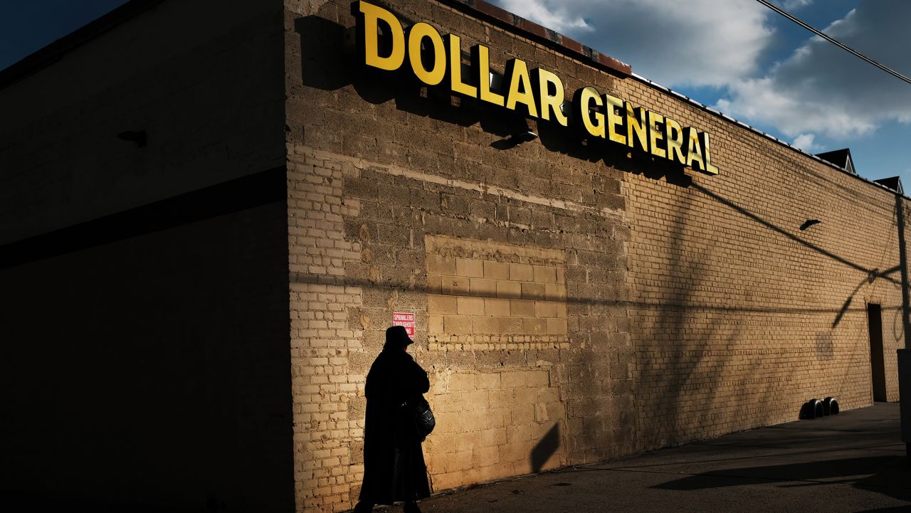 A woman walks by a Dollar General store on December 11, 2018 in the Brooklyn borough of New York City.