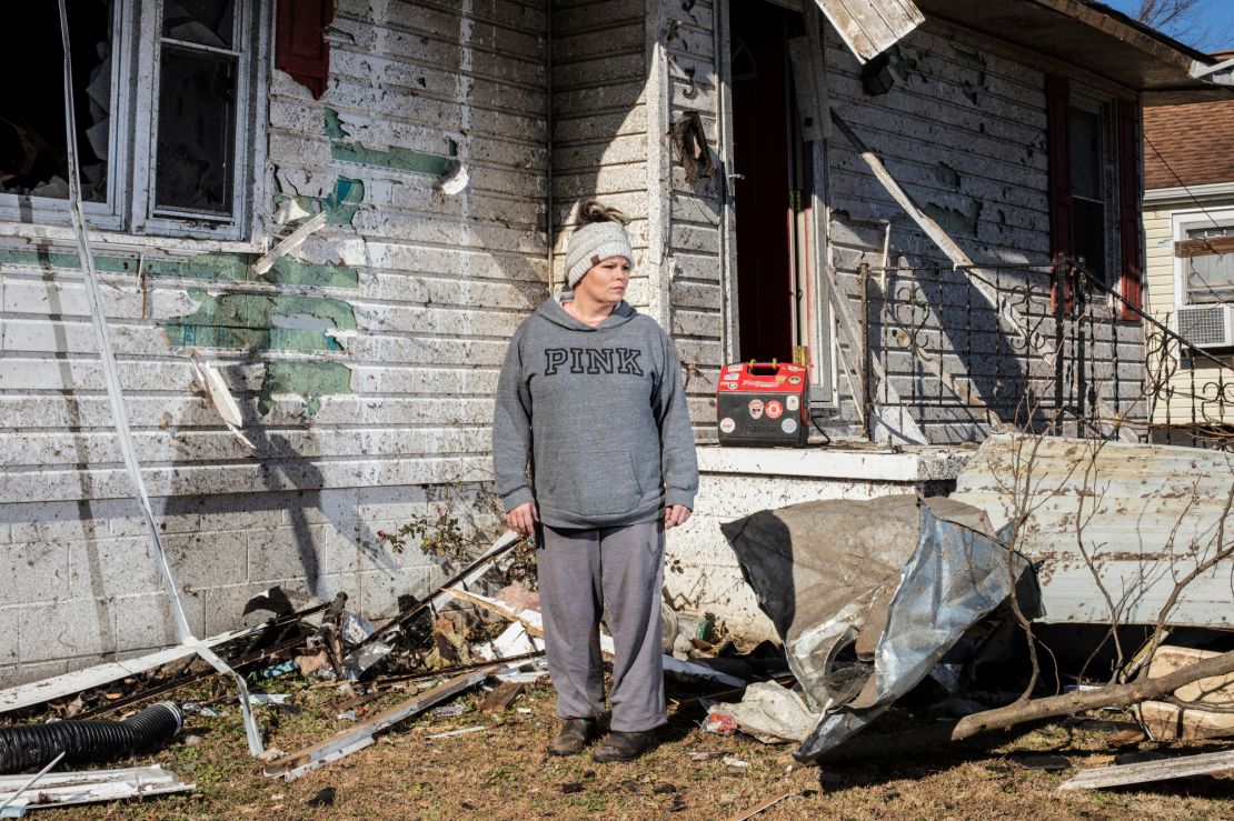 Melissa Lamb stands in front of her detroyed home in Dawson Springs.