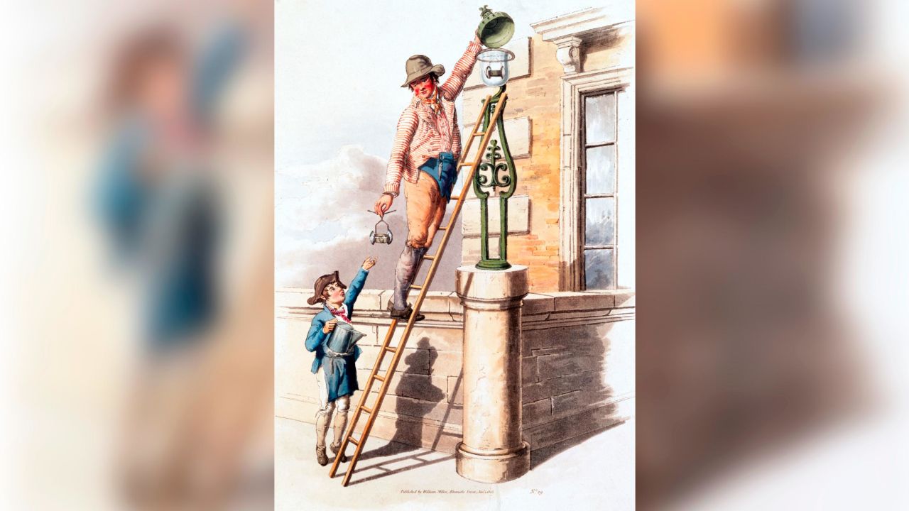 The image shows a lamplighter up a ladder. British streets were lit by oil lamps until the introduction of gas lighting around 1807. 