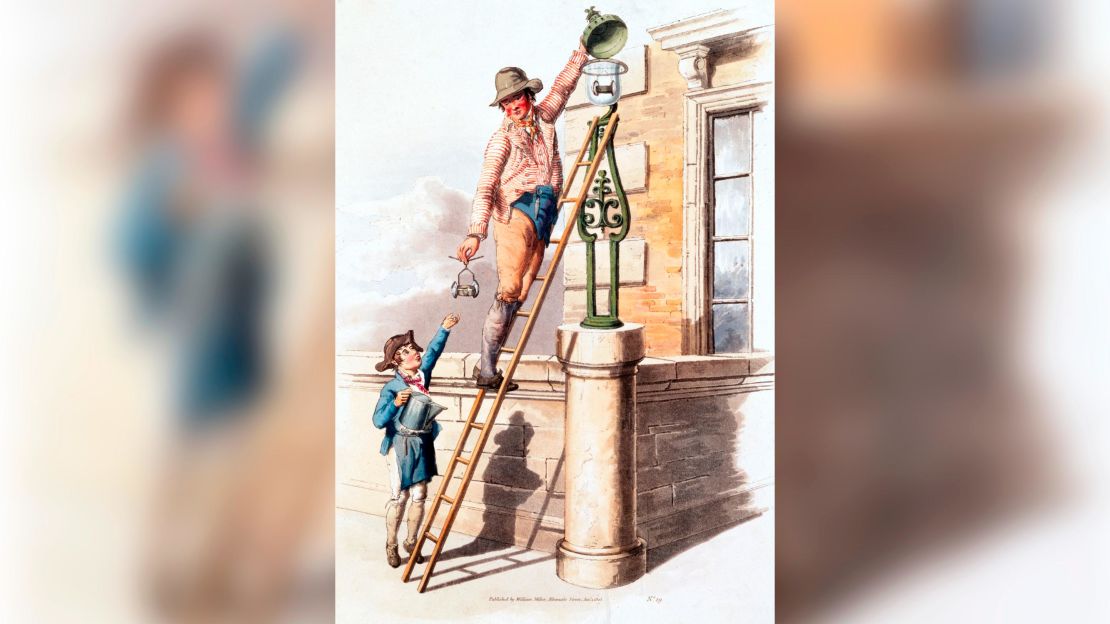 The image shows a lamplighter up a ladder. British streets were lit by oil lamps until the introduction of gas lighting around 1807.