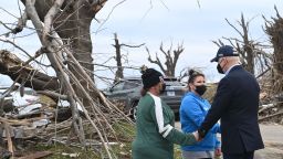 US President Joe Biden embraces residents as he tours storm damage in Dawson Springs, Kentucky, on December 15, 2021. - Biden will tour areas devastated by the December 10-11 tornadoes. 