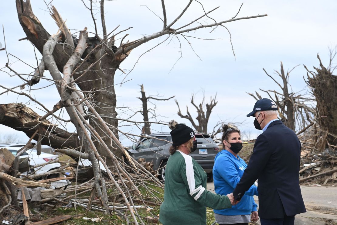 US President Joe Biden embraces residents as he tours storm damage in Dawson Springs, Kentucky, on December 15, 2021. - Biden will tour areas devastated by the December 10-11 tornadoes. 