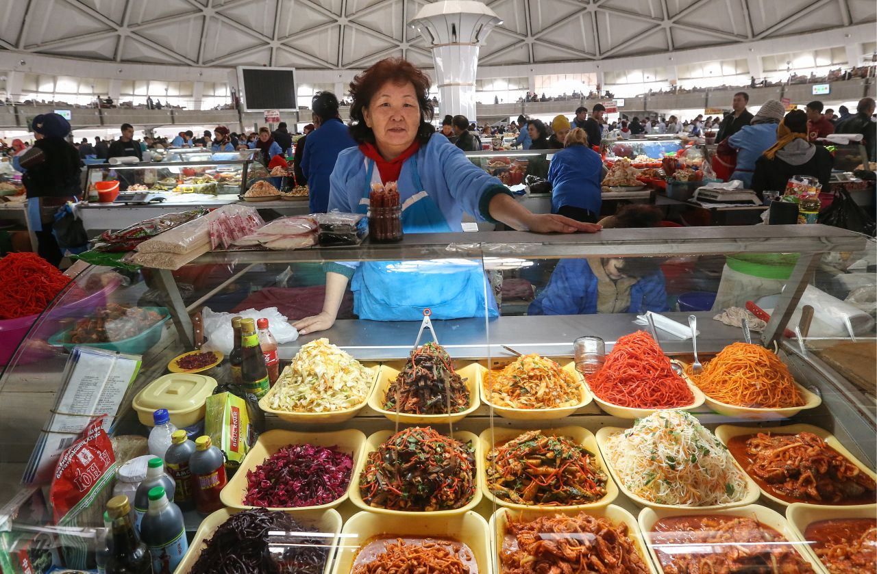 A woman selling pickled vegetables at the Chorsu street food market.