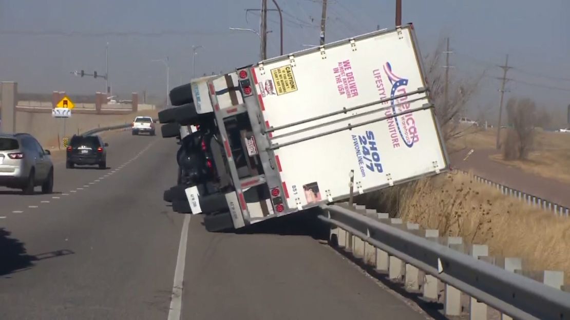 A tractor-trailer on Interstate 25 was knocked over by high winds in El Paso County, Colorado. 