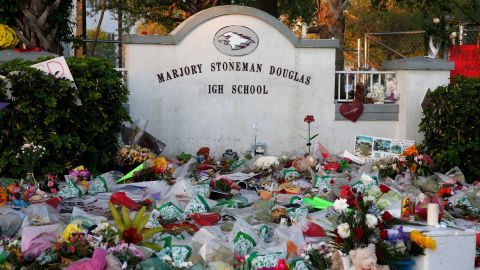 Flowers, candles and mementos sit outside one of the makeshift memorials at Marjory Stoneman Douglas High School in Parkland, Florida in this file photo from 2018.
