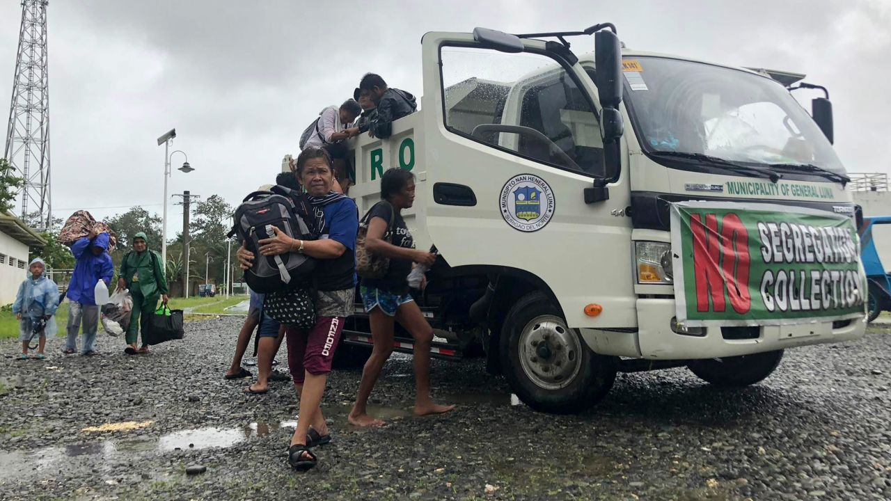 Evacuees arrive at an evacuation site in Dapa town, Surigao, Philippines on December 16.