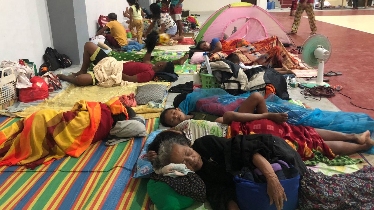 Residents sleep inside a sports complex turned into an evacuation center in Dapa town, Surigao, the Philippines, on December 16.
