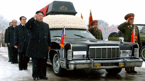 Kim Jong Un salutes beside his father's hearse during his funeral procession in Pyongyang on December 28, 2011.