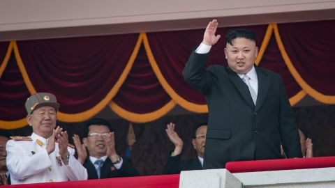 North Korean leader Kim Jong Un waves from a balcony following a military parade in Pyongyang on April 15, 2017.