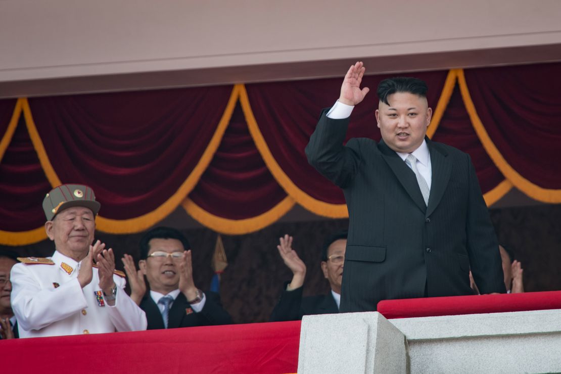 North Korean leader Kim Jong Un waves from a balcony following a military parade in Pyongyang on April 15, 2017. 